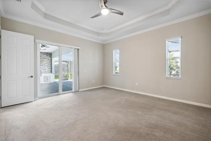 This bedroom features a slider leading to the lanai, pool and spa.