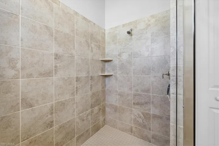 Spacious walk in shower in the Primary bedroom.
