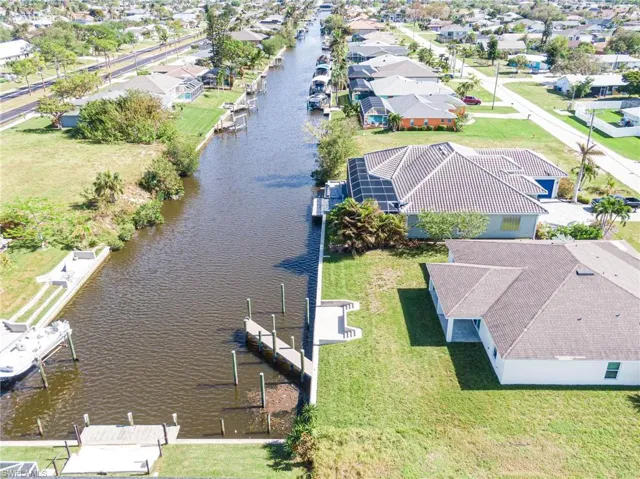 Aerial perspective of suburban area with a large body of water