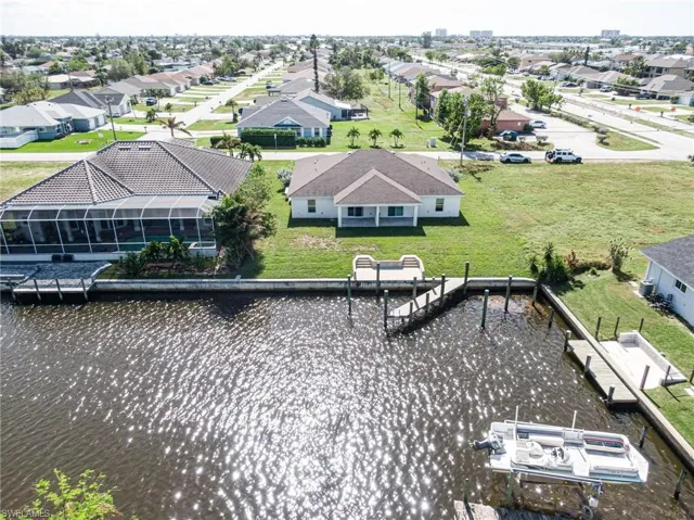 Aerial perspective of suburban area with a large body of water