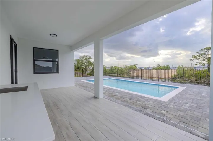 View of pool featuring a patio, a fenced in pool, and a fenced backyard