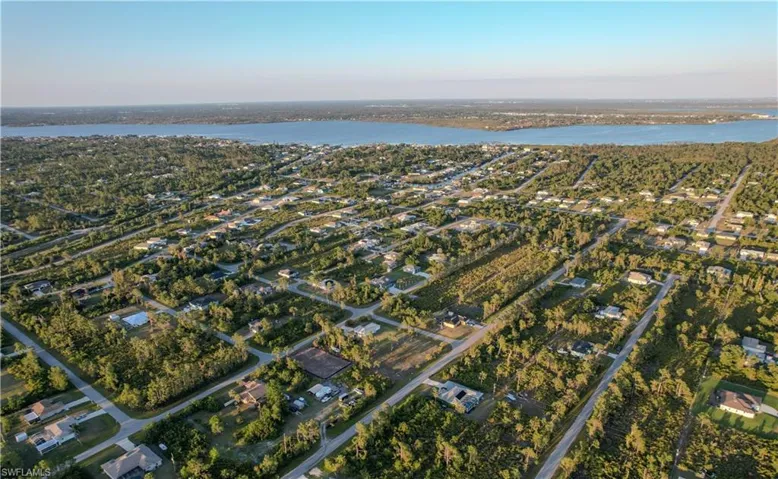 Birds eye view of property with a residential view and a water view