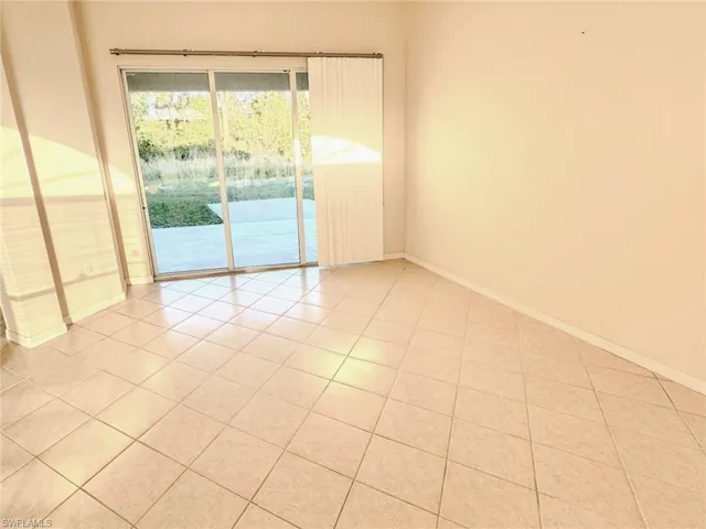 Unfurnished room featuring baseboards and light tile patterned floors