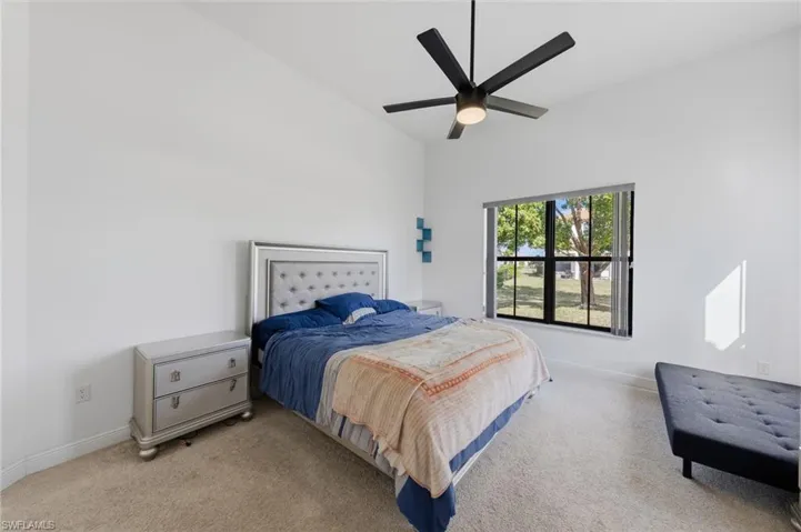 Carpeted bedroom with baseboards and ceiling fan
