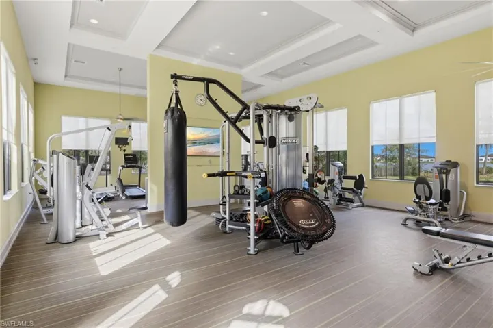 Exercise room with ceiling fan, crown molding, coffered ceiling, and recessed lighting