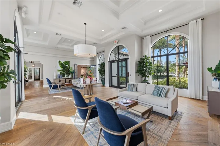 Living area featuring french doors, light wood finished floors, coffered ceiling, and recessed lighting