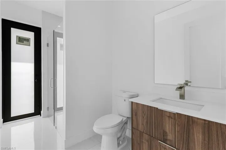 Bathroom with vanity, toilet, and tile patterned floors
