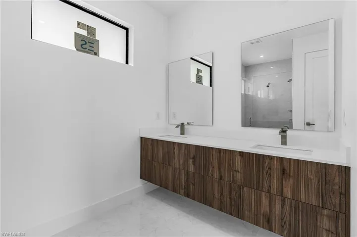 Bathroom with vanity and a shower with shower door