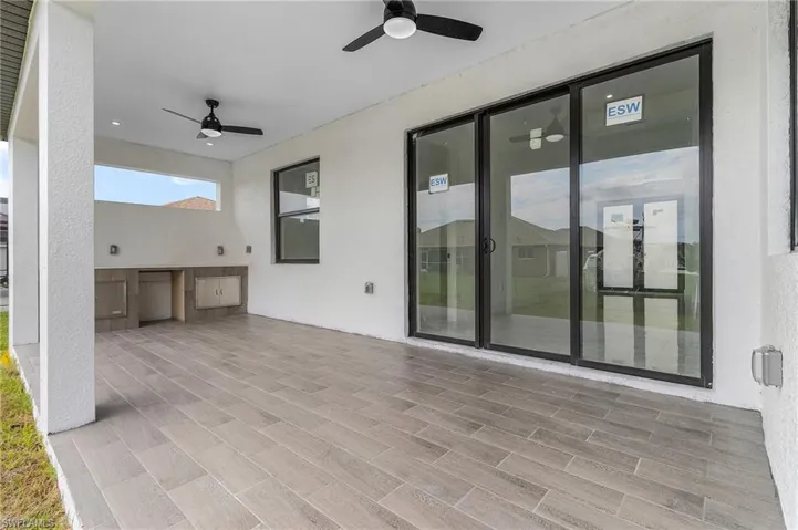 View of patio / terrace with ceiling fan and an outdoor kitchen