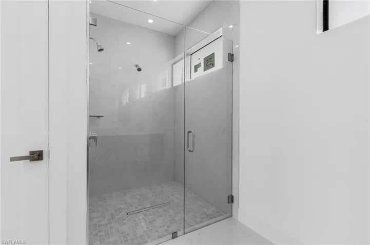Bathroom with a shower with shower door