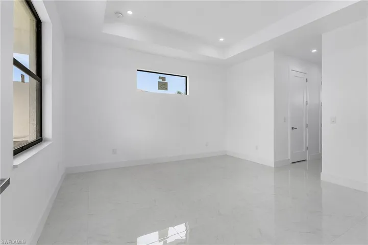 Unfurnished room featuring a tray ceiling