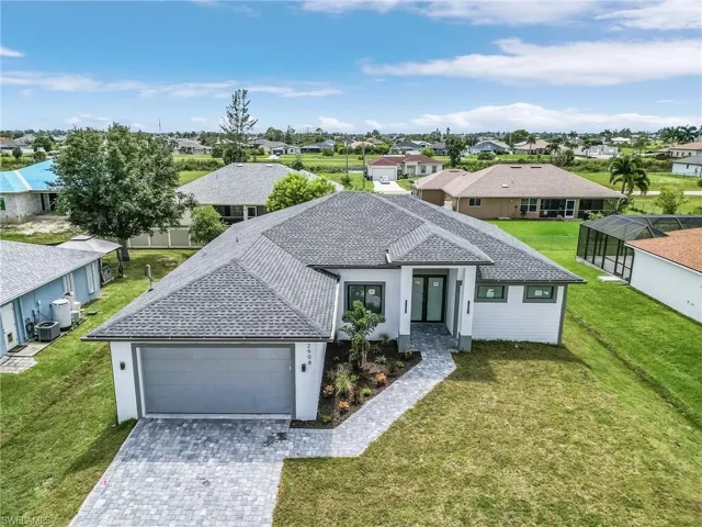 View of front of house with a front lawn and a garage