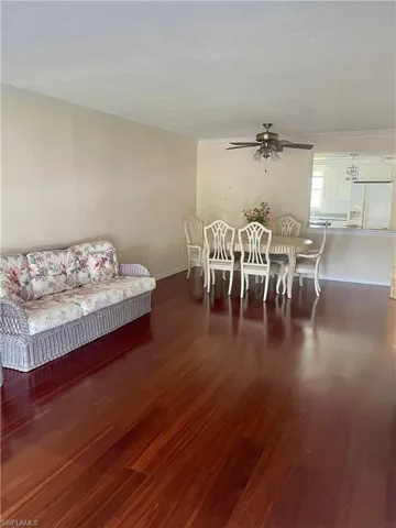 Dining space with crown molding, dark hardwood / wood-style floors, and ceiling fan