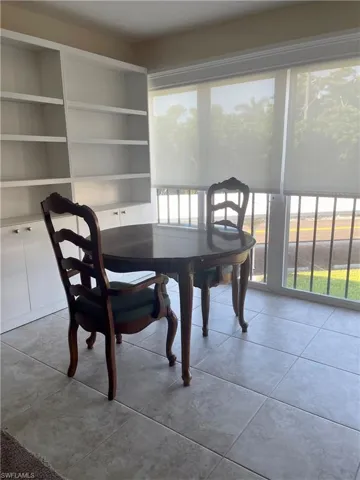 Tiled dining space with built in shelves