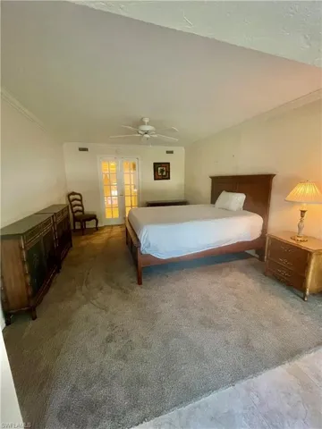 Bedroom with crown molding, french doors, and ceiling fan