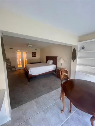 Tiled bedroom with french doors