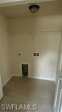 Laundry area featuring baseboards and hookup for an electric dryer