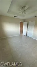 Unfurnished bedroom featuring a ceiling fan and concrete floors