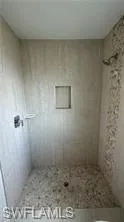 Full bathroom featuring a shower stall