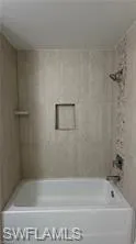 Bathroom with shower / washtub combination