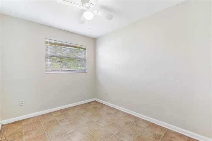 Spare room with baseboards and ceiling fan