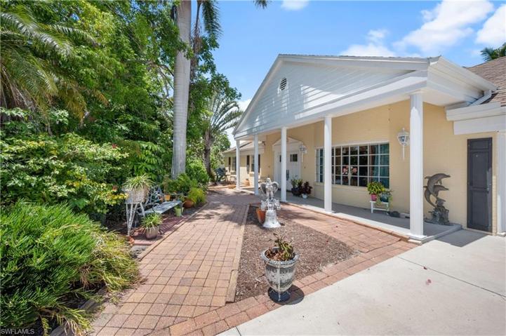 Angled view o front of structure.  Beautiful landscaped yard allows for privacy from the road.