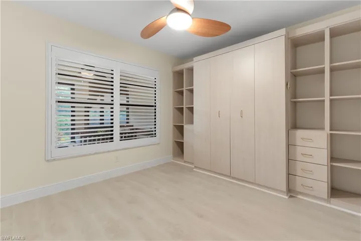 Second Bedroom has Plantation Shutters, Murphy Bed with Shelving.