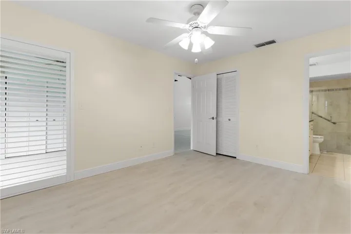 Primary bedroom suite has updated bathroom + walk-in closet.