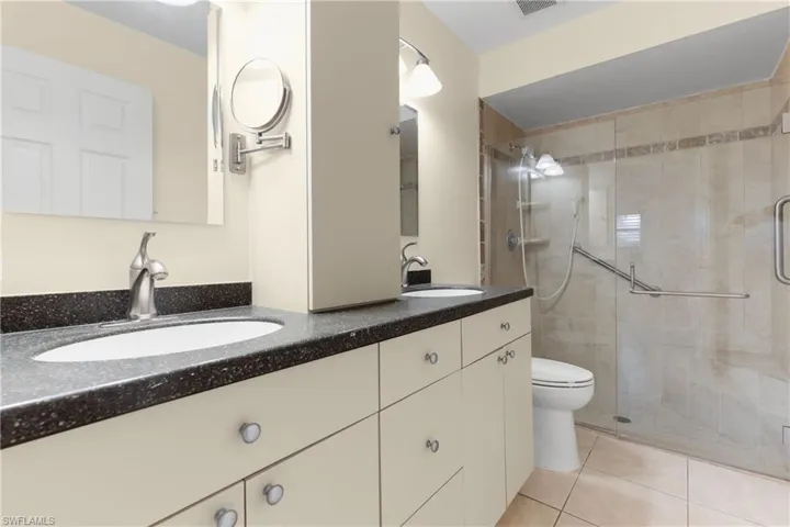 Primary Bath has Large Glass Enclosed Walk-in Shower with Safety Bar.