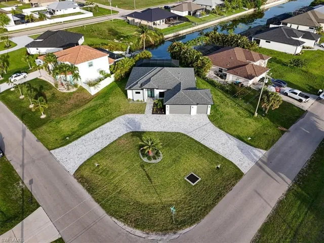 Aerial perspective of suburban area featuring a nearby body of water