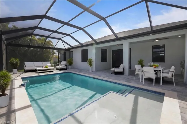 Swimming pool featuring an outdoor living space, a patio area, a ceiling fan, and outdoor dining space