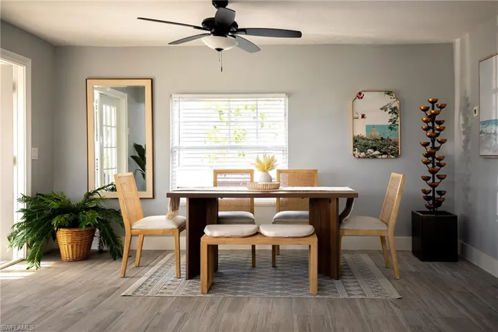 Dining space with wood finished floors and a ceiling fan
