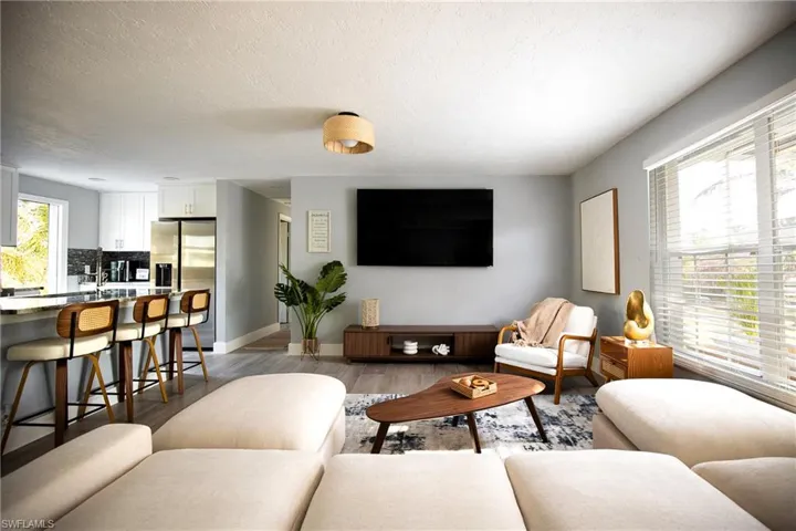 Living room with light wood-style flooring and a textured ceiling