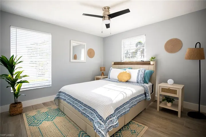 Bedroom with wood finished floors and a ceiling fan