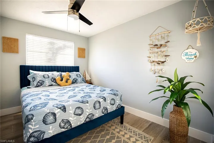 Bedroom featuring wood finished floors and a ceiling fan