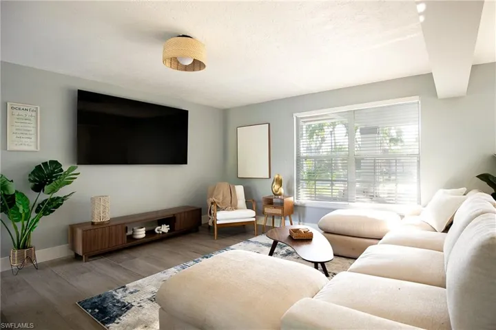 Living room featuring wood finished floors and a textured ceiling