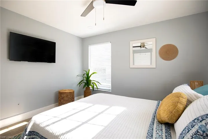 Bedroom featuring a ceiling fan and baseboards