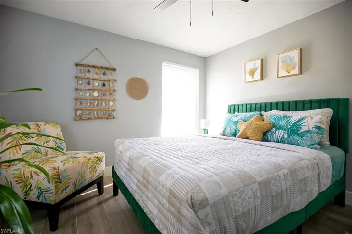 Bedroom featuring dark wood-type flooring and ceiling fan