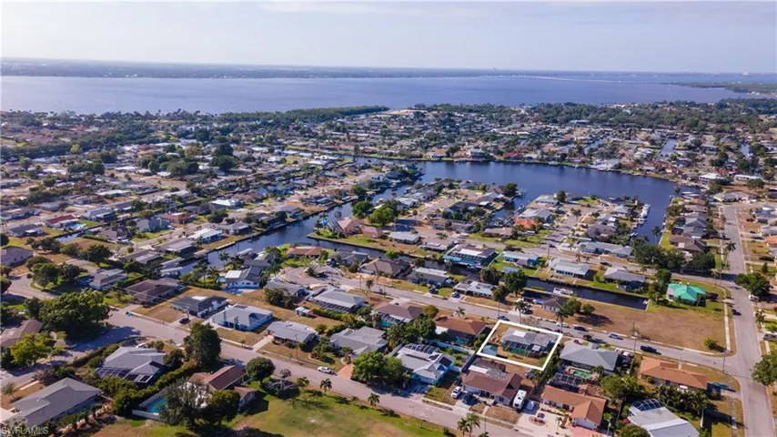 Aerial view featuring a water view and a residential view