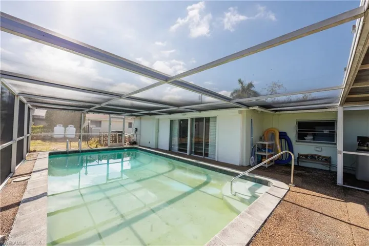 Outdoor pool with a lanai and a patio