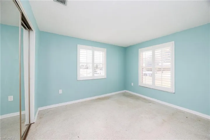 Unfurnished bedroom with baseboards, a closet, and visible vents