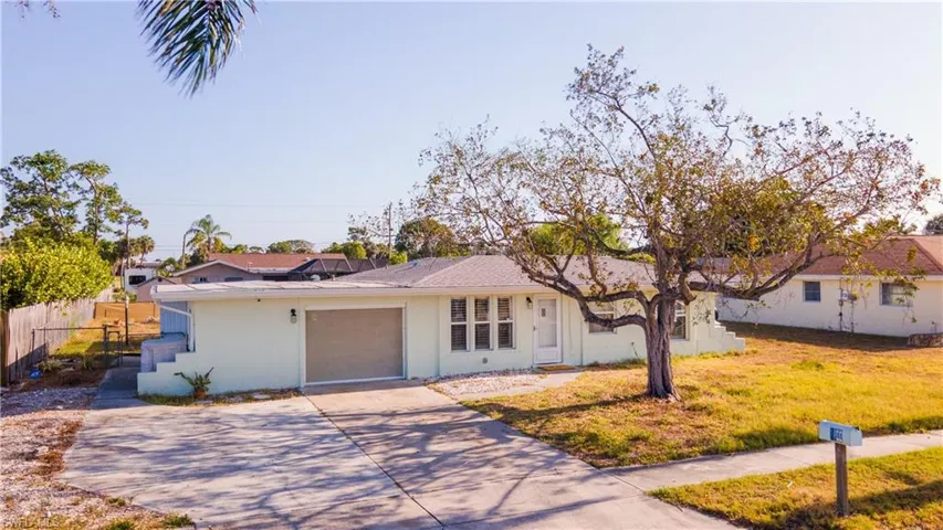 Single story home with stucco siding, a garage, fence, and concrete driveway