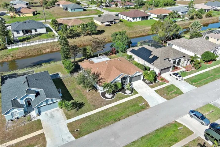 Aerial perspective of suburban area with a large body of water