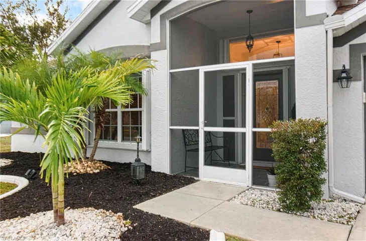Doorway to property with stucco siding and a sunroom
