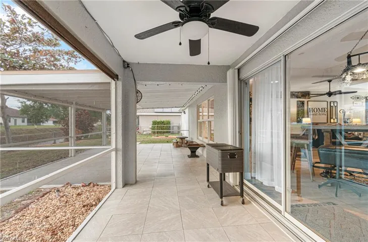 Sunroom / solarium featuring ceiling fan