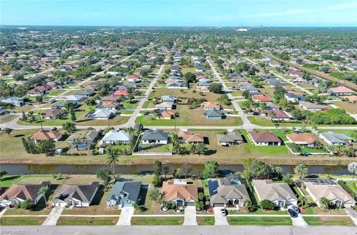 Aerial view of property's location featuring nearby suburban area and a large body of water