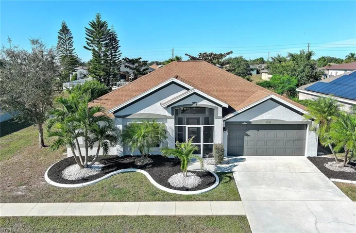 View of front of house featuring stucco siding, a garage, and concrete driveway