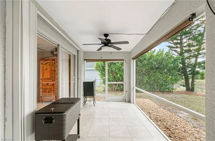 Sunroom featuring a ceiling fan