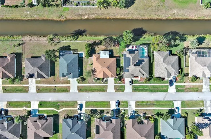 Aerial overview of property's location featuring nearby suburban area and a nearby body of water