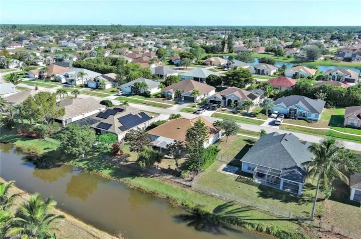 Aerial view of residential area featuring a nearby body of water